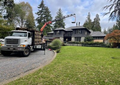 Truck with boom loading cedar shakes on to a roof
