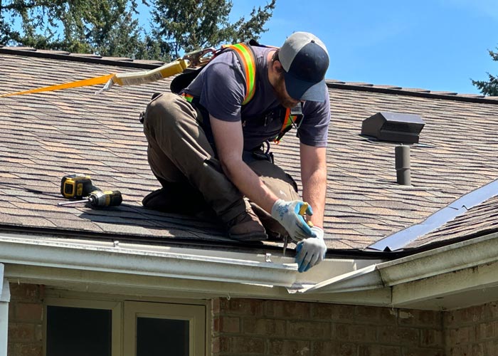 Man on roof performing a repair
